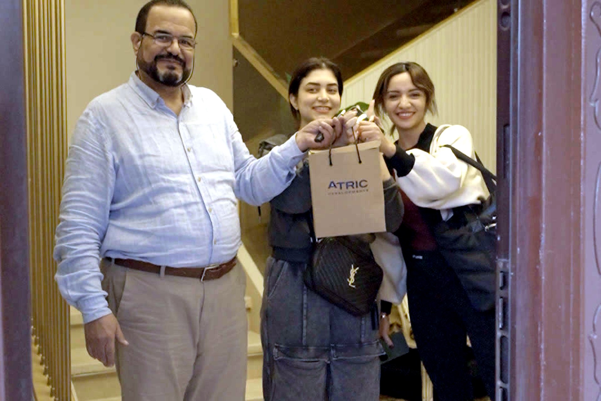 Smiling residents receiving Christmas gifts at Divina Gardens